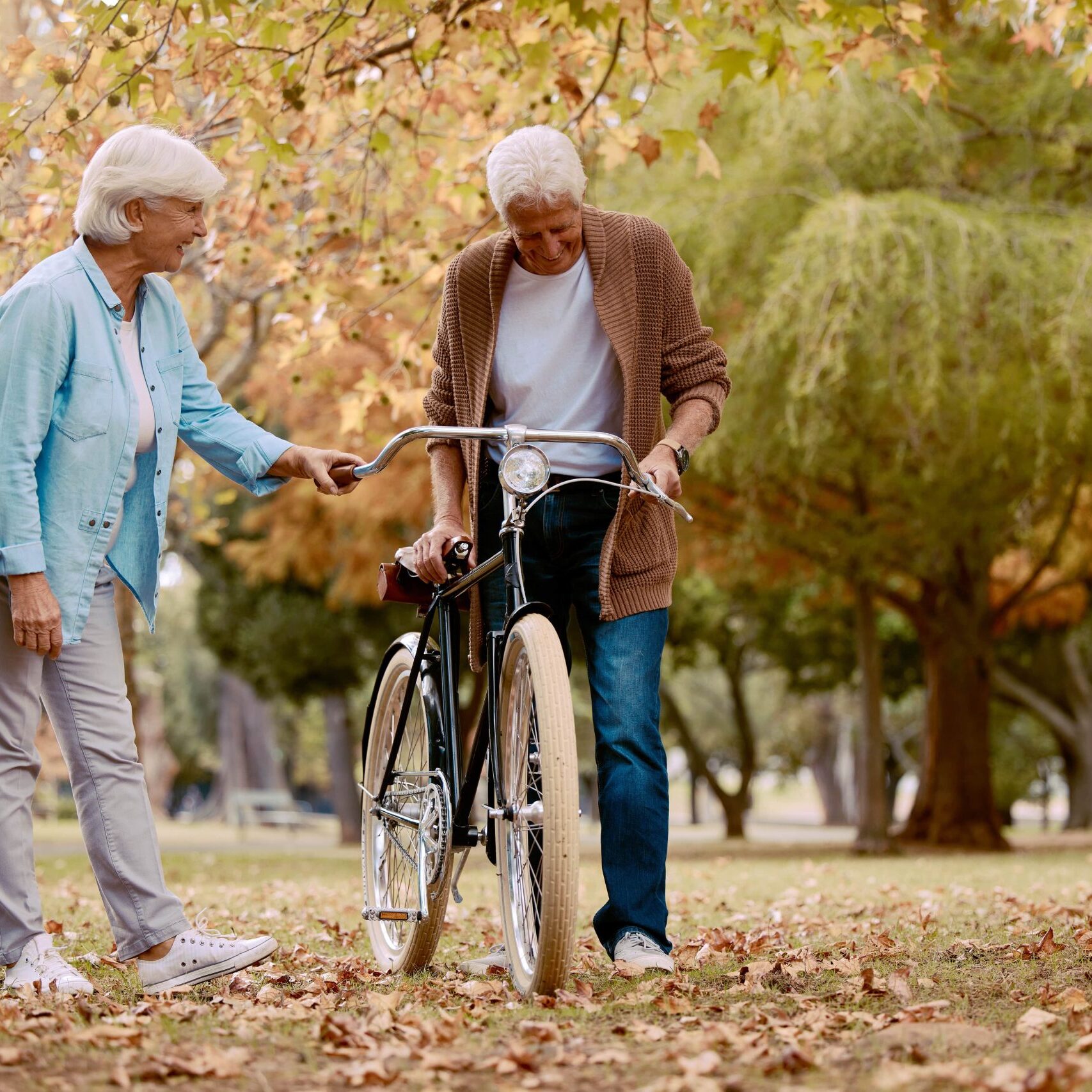 senior-couple-walking-and-bike